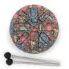Circular steel tongue drum with colourful mandala pattern and two mallets.