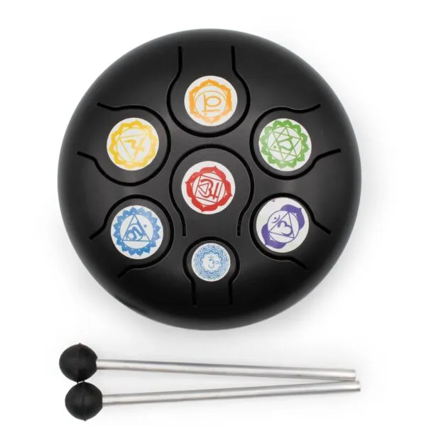 A black steel tongue drum with colourful chakra symbols and two mallets.