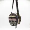 Colourful round Andean woven cross-body shoulder bag with black straps.