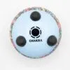 Underside of a light blue steel tongue drum with a colourful paisley pattern.