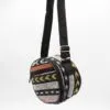 A colourful cylindrical woven shoulder bag featuring geometric patterns on a white background.