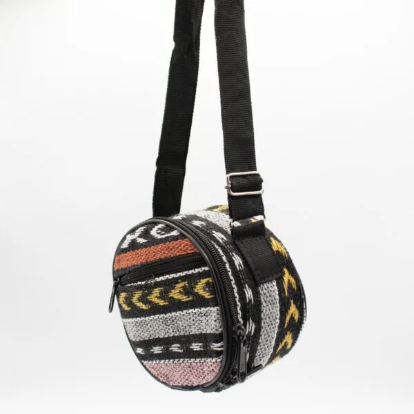 A colourful cylindrical woven shoulder bag featuring geometric patterns on a white background.