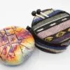 Colourful cosmic steel tongue drum and patterned fabric carrying bag with mallets.