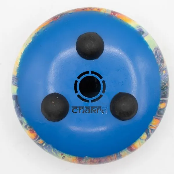 Underside of a blue circular tongue drum with rubber feet on a white background.