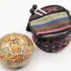A colourful steel tongue drum alongside a patterned carrying bag with drumsticks.