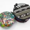 Colourful steel tongue drum with a patterned carrying case and two drum mallets.