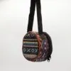Colourful round patterned fabric bag with a black strap against a white background.