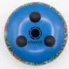 Colourful, hand-painted bottom of a round percussion instrument with black rubber feet.