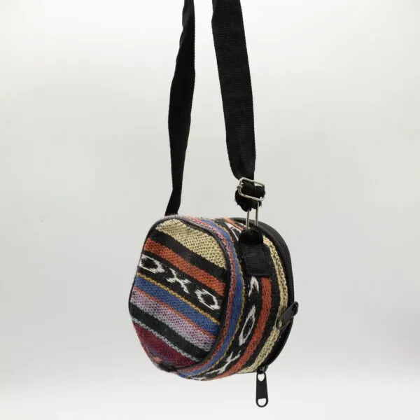 Multicoloured round woven wool crossbody bag featuring a geometric diamond pattern and zip closure.