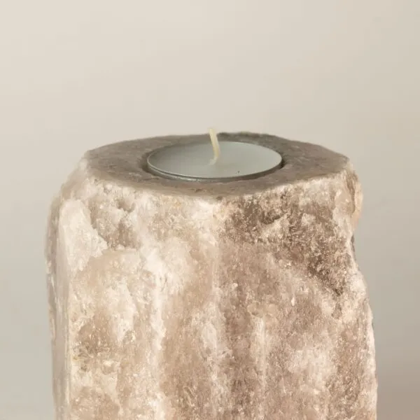 Tealight Candle Holder Natural Quartz Beige Rough Texture Rough natural beige quartz rock tealight holder with an unlit white candle.