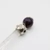 Clear quartz crystal wand topped with a silver filigree cat cap and amethyst sphere.