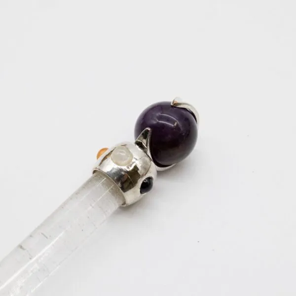 Clear quartz crystal wand topped with a silver filigree cat cap and amethyst sphere.