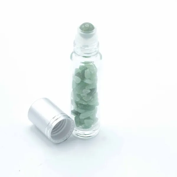 Glass rollerball bottle filled with green aventurine gemstone chips alongside a silver cap.