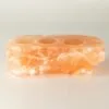 Rough-hewn triple tea light candle holder made from natural Himalayan pink salt.