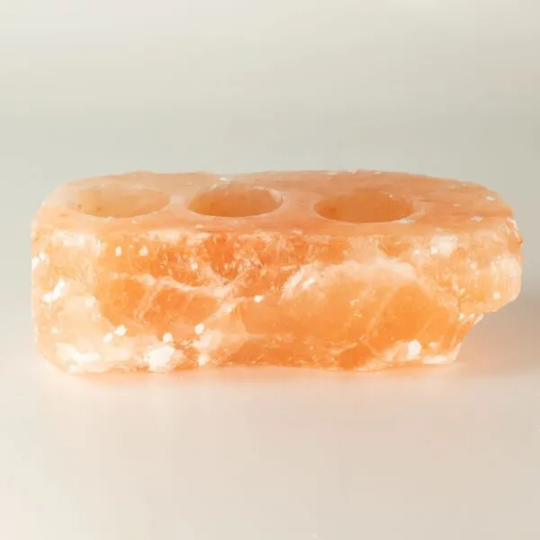 Rough-hewn triple tea light candle holder made from natural Himalayan pink salt.
