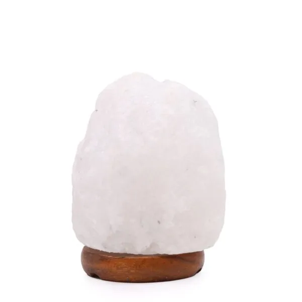 Unfinished white rock salt crystal lamp on a rounded dark wooden base.