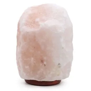 Large natural pale pink Himalayan salt rock lamp on a dark wooden base.