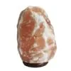 Raw Himalayan pink salt crystal lamp on a dark wooden base.
