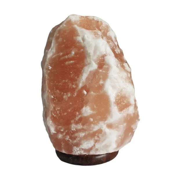 Raw Himalayan pink salt crystal lamp on a dark wooden base.
