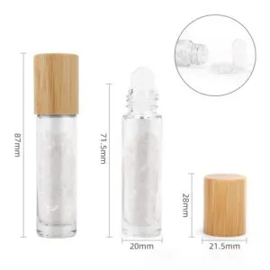 Clear glass roller bottles with bamboo caps, filled with quartz crystals and displaying dimensions.