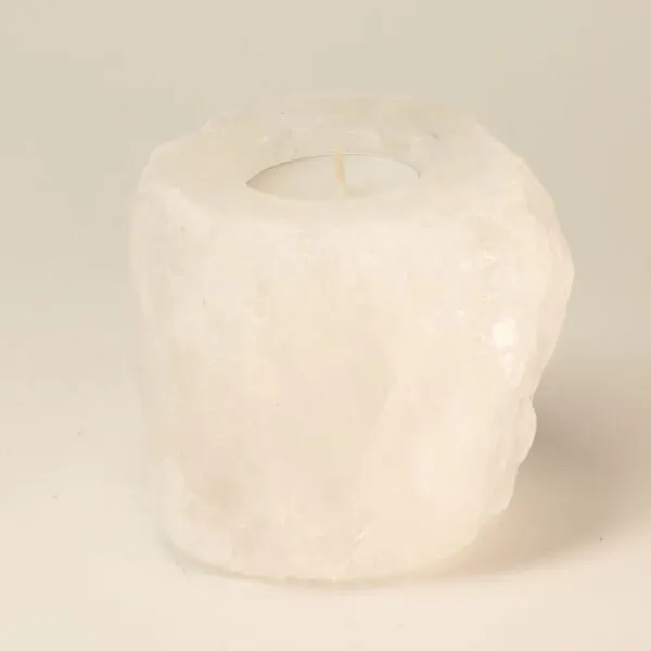 Carved white rock salt pillar tea light holder with a natural crystalline texture.