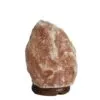 Natural pink Himalayan salt rock crystal lamp set on a dark wooden base.