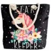 Black canvas tote bag with cream rope handles and a Star Keeper unicorn design.