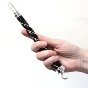 Ornate Magic Wand Wire Wrapped Black And Silver Crystal Tip Hand holding an ornate black and silver wire-wrapped magic wand with a crystal tip.