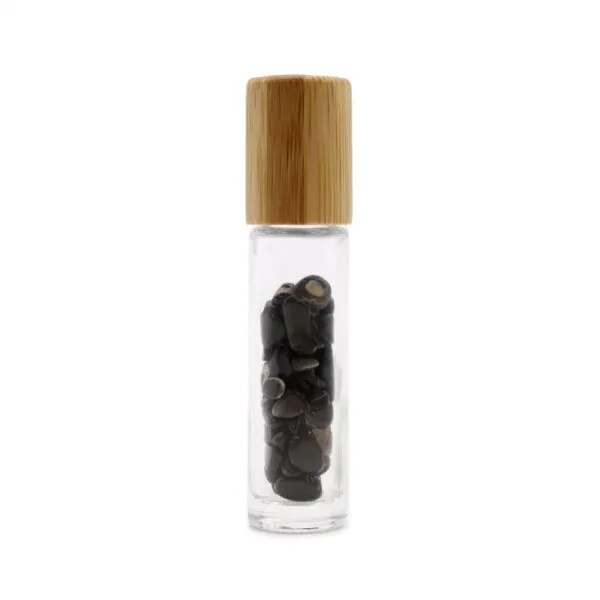 Clear glass rollerball bottle with a bamboo cap, filled with polished black gemstone chips.