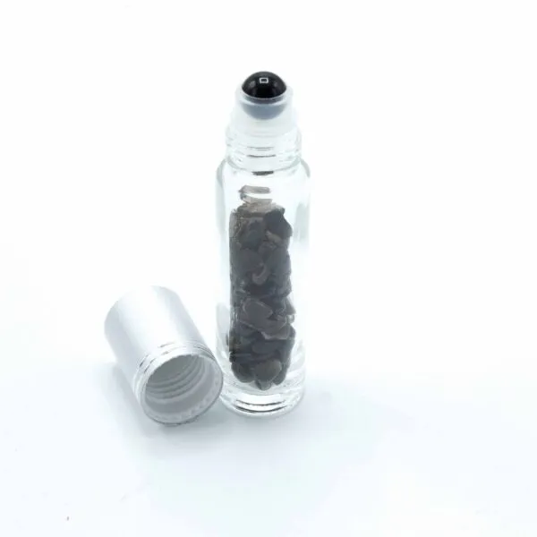 Clear glass gemstone roller bottle filled with black stone chips and a silver cap.