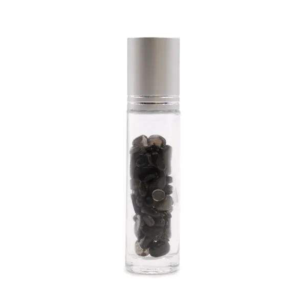 Clear glass roller bottle filled with dark black tourmaline gemstone chips and silver cap.