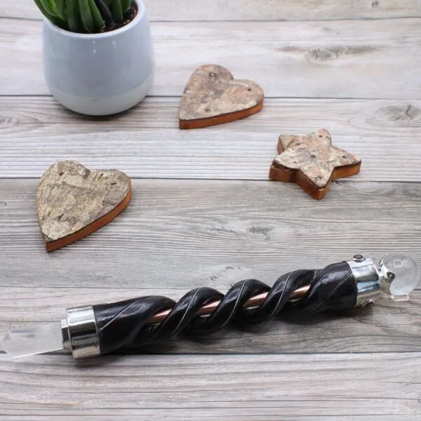 Black twisted wooden magic wand with a clear crystal ball and point.