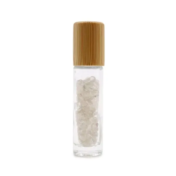 Clear glass essential oil roller bottle filled with gemstone chips and a bamboo cap.