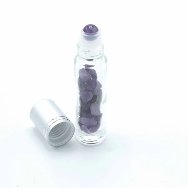 Clear glass essential oil roller bottle with purple gemstones and an open silver cap.