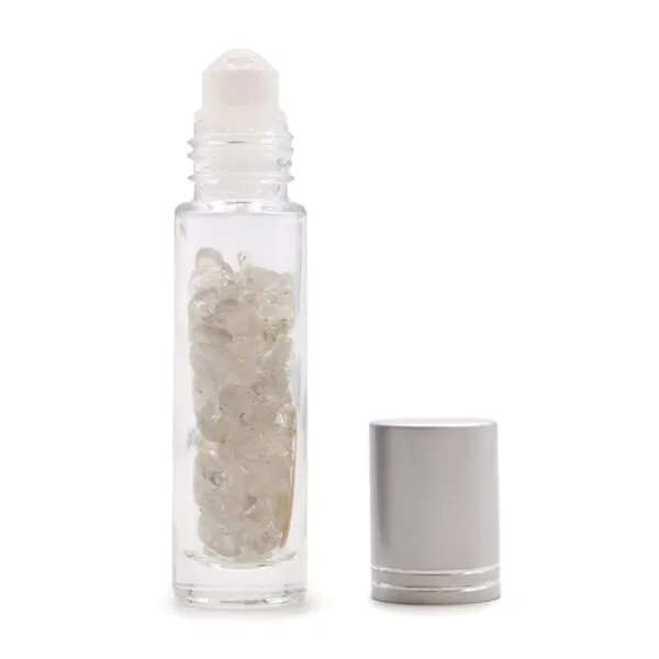 Clear glass essential oil roller bottle filled with white quartz crystals and silver cap.