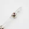 Clear quartz crystal wand featuring a sterling silver band set with a red cabochon gemstone.