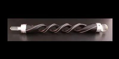 Dark wood decorative wand with silver wire inlay and clear crystal ends.