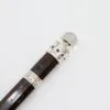 Handcrafted dark wood magic wand featuring ornate silver filigree and red ruby gemstones.