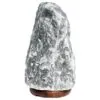 A rough grey Himalayan salt lamp on a dark polished wooden base.