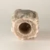 Cylindrical Salt Block Natural Rock Grey With Central Hole A natural grey cylindrical rock salt block with a central drilled hole.