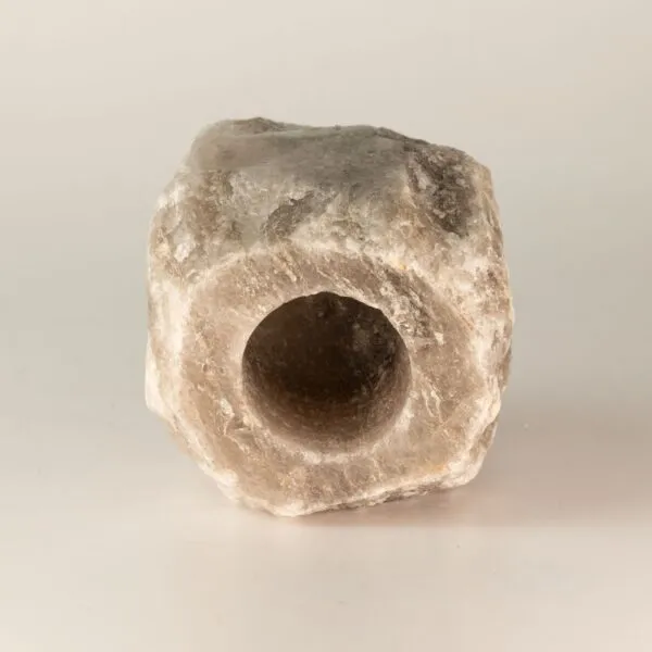 Cylindrical Salt Block Natural Rock Grey With Central Hole A natural grey cylindrical rock salt block with a central drilled hole.