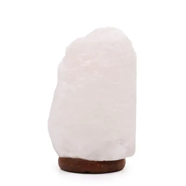 Unpolished light pink Himalayan rock salt lamp on a dark wooden base.