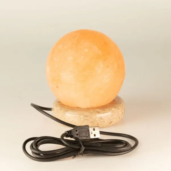 Sphere Salt Lamp Himalayan Rock Salt Peach USB Powered Spherical peach Himalayan rock salt lamp on a stone base with USB cable.