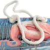 Light blue tapestry tote bag featuring a woven pink flamingo and white rope handles.