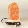 Pink Himalayan rock salt lamp glowing with warm light, powered by USB.