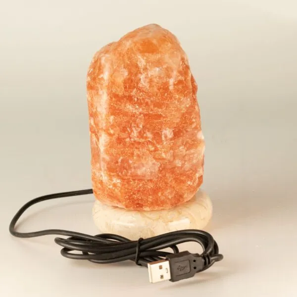 Pink Himalayan rock salt lamp glowing with warm light, powered by USB.