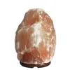 Natural pink Himalayan salt crystal lamp set on a dark wooden base.