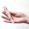 Healing Wand Rose Quartz Pink Dual Ended Silver Gemstones Hand holding a dual-ended rose quartz healing wand with ornate silver gemstone fittings.