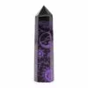 Polished black obsidian crystal tower featuring purple glitter celestial sun and moon engravings.