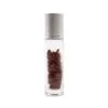 Clear glass rollerball bottle containing dark red jasper crystals with a brushed silver cap.